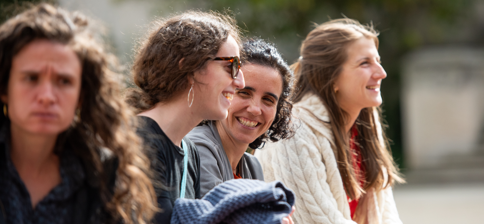 graduate students laughing and talking outdoors